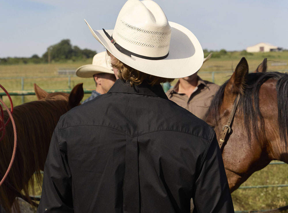 A man wearing a straw cowboy hat.